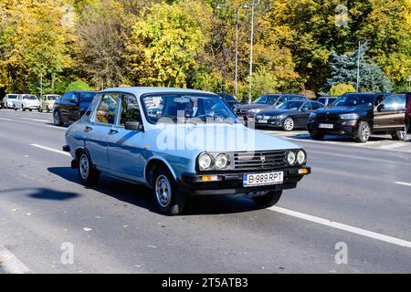 Bucharest, Romania, 24 October 2021: Old vivid blue Romanian Dacia 1310 classic car in traffic in the city center, in a sunny autumn day Stock Photo