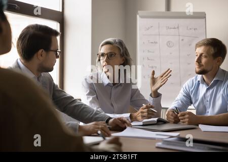 Serious elder business leader woman discussing project Stock Photo