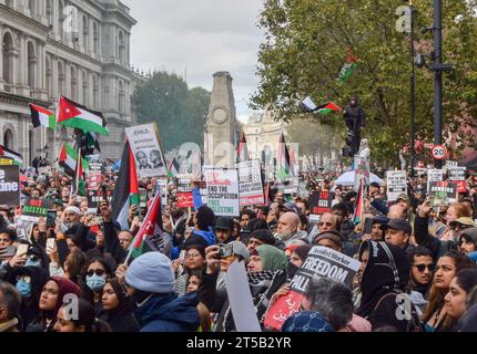 London, UK. 21st October 2023. Protesters gather around The Cenotaph in Whitehall. Tens of thousands of people marched in central London in solidarity with Palestine as the Israel-Hamas war intensifies. Stock Photo