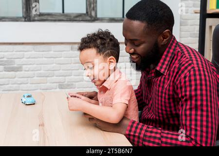 Black father son using tablet Stock Photo