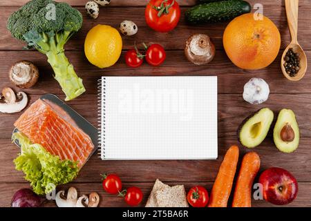 Flat lay notebook with lots vegetables salmon Stock Photo