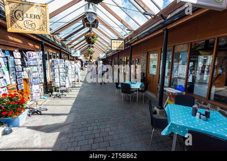 Interior of Great Torrington Pannier Market, Shops and Glass Roof Detail Looking Towards the Main Town Entrance and Torrington Square #4 Stock Photo