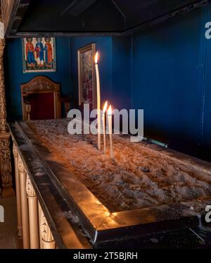 Burning candles inside a Greek monastery. Stock Photo