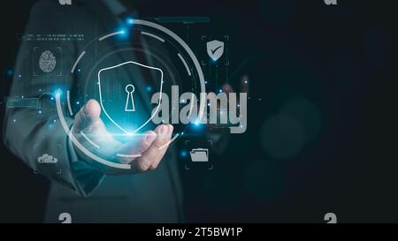 Businessman holds phone and login padlock icon Represents protection against external hacking of the system. Security concepts for protecting against Stock Photo