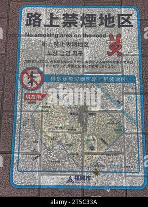 Fukuoka, Hakata, Japan. Sidewalk Sign Telling Pedestrians Smoking is not Allowed within Area Defined by Map. Stock Photo