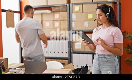 Man and woman ecommerce business workers having video call working at office Stock Photo