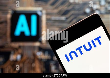 In this photo illustration, the American business software company Intuit logo seen displayed on a smartphone with an Artificial intelligence (AI) chip and symbol in the background. Stock Photo