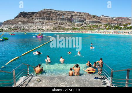 GRAN CANARIA, SPAIN - AUG 04, 2023: Playa de Amadorus is one of the most popular beaches on Canary Island Gran Canaria. Stock Photo