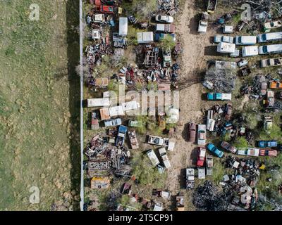 Automotive junk yard with room for print.  Classic cars, antiques and busses.  RVs forgotten in this rusting old place. Watch where you step. Stock Photo