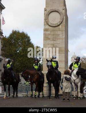 two mounted Met police officers riding horses through chinatown soho ...