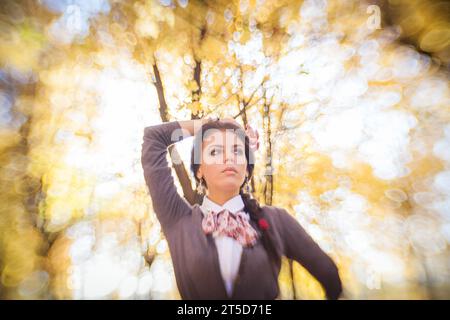 In this mesmerizing portrait, a brunette woman takes center stage amidst the enchanting colors of autumn. The unique and powerful background blur, ach Stock Photo