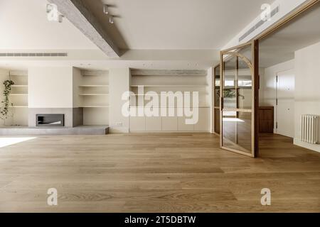 Large unfurnished living room with a built-in bookcase Stock Photo