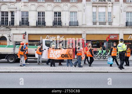 Just Stop Oil protestors slowly march along The Strand, creating mild traffic.   Image shot on 24th Apr 2023.  © Belinda Jiao   jiao.bilin@gmail.com 0 Stock Photo