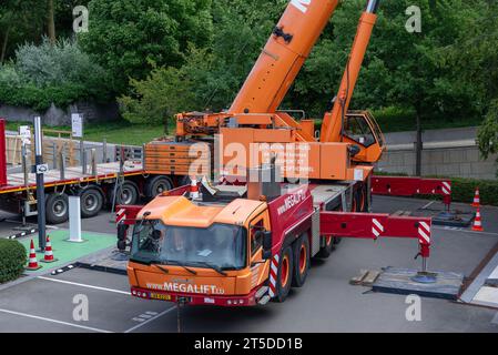 Orange mobile crane Grove GMK6300L on construction site Stock Photo