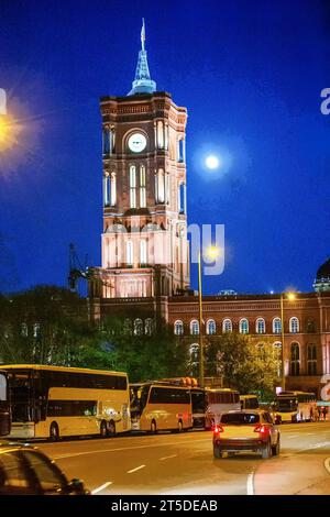 Town hall Rotes Rathaus  (Clock tower) next to Alexanderplatz   - awe night view with tourist buses in parking lots (Maybe from Netherlands) Behind mo Stock Photo