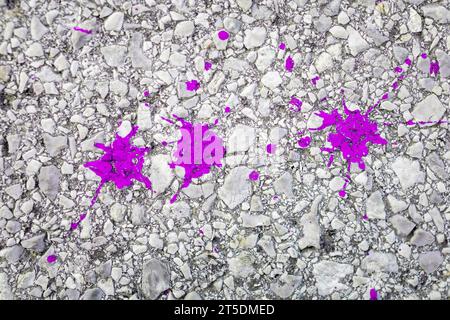 Pink colored splashes on the ground. Background, copy space Stock Photo