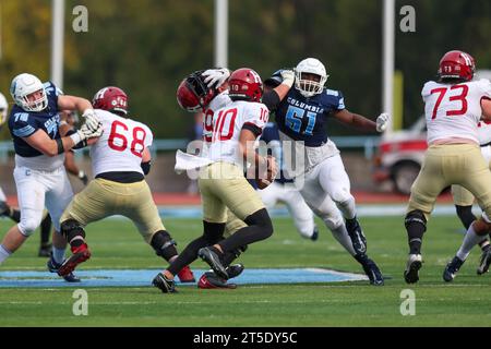 Harvard Crimson quarterback Jaden Craig #10 goes back to avoid pressure from Columbia Lions defensive lineman Quentin Autry #51 in the NCAA football game at Robert K. Kraft Field at Lawrence A. Wien Stadium in New York , New York , Saturday, Nov. 4, 2023. (Photo: Gordon Donovan) Stock Photo