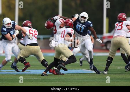 Harvard Crimson quarterback Jaden Craig #10 goes back to avoid pressure from Columbia Lions defensive lineman Quentin Autry #51 in the NCAA football game at Robert K. Kraft Field at Lawrence A. Wien Stadium in New York , New York , Saturday, Nov. 4, 2023. (Photo: Gordon Donovan) Stock Photo