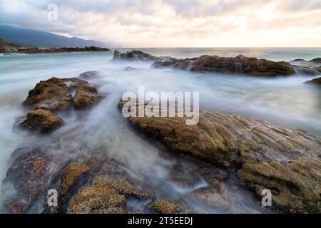 A Beautiful Ocean Sunset With A Wave Breaking On Shore High Resolution Stock Photo