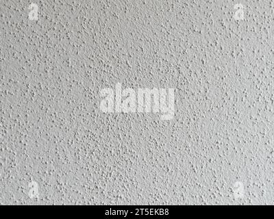 Interior plaster with a sand finish. The structure is like a woodchip wallpaper. White wall texture in a domestic room at home with a stucco pattern. Stock Photo