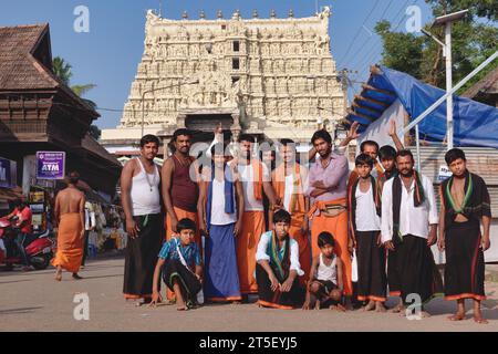 A group of exclusively male Hindu pilgrims posing for photos in front of Padmanabhaswamy Temple in Trivandrum (Thirivanathapuram), Kerala, India Stock Photo