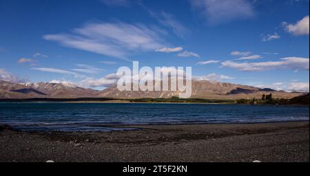 View across lake at Lake Pukaki in Southland New Zealand 2023. Magical place where you can see the lake, snow capped peaks and beautiful skies. Stock Photo