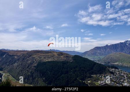 Hang glider sailing across the sky at Queenstown in New Zealand. So quiet up here and so serene and the view is breathtaking. Stock Photo