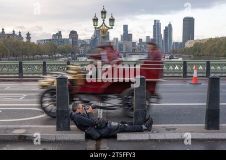 Westminster Bridge, London, UK. 5th Nov, 2023. RM Sotheby’s London to Brighton Veteran Car Run crosses Westminster Bridge on the way to the South Coast in its 127th year. Taking part in the run are the original two cars, a Darracq (27) and a Spyker (14), which featured in the British comedy film Genevieve 70 years ago in 1953. Credit: Malcolm Park/Alamy Live News Stock Photo