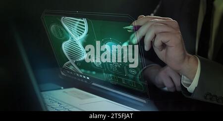 A man works on a laptop in front of which infographics about medicine and modern technologies are projected. Stock Photo