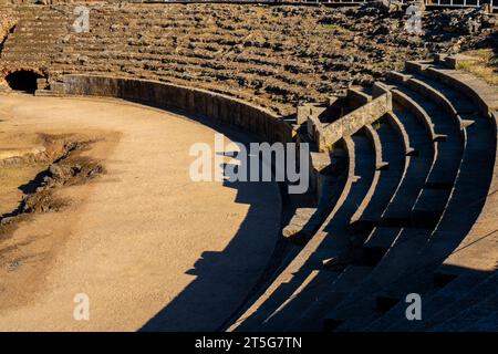 Steps of the Roman Amphitheater of Mérida illuminated by the light of dawn creating shadows from its steps in Badajoz, Extremadura, Spain. World Herit Stock Photo