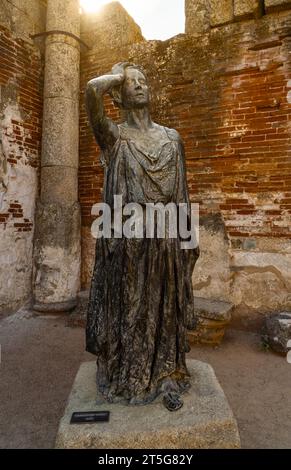 Tribute in bronze statue of the actress Margarita Xirgu in a courtyard of columns of the Roman Theater of Mérida with the backlit sunlight illuminatin Stock Photo