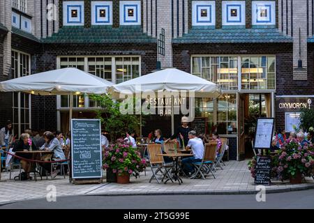 Berlin, Germany, July 20: Residents and guests of the city relax in a cozy restaurant located in a courtyard in Berlin on July 20, 2023. Stock Photo
