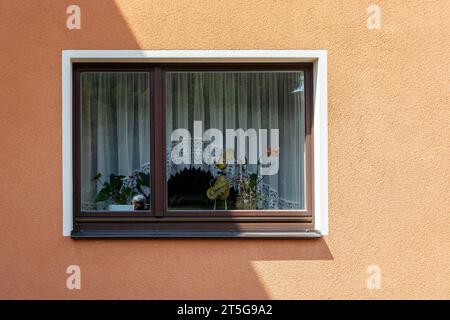 Rectangular window with a white frame on a pink plastered wall. From the series Window of the World. Stock Photo