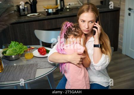 Anxious woman worrying about her little daughter who feeling sick Stock Photo