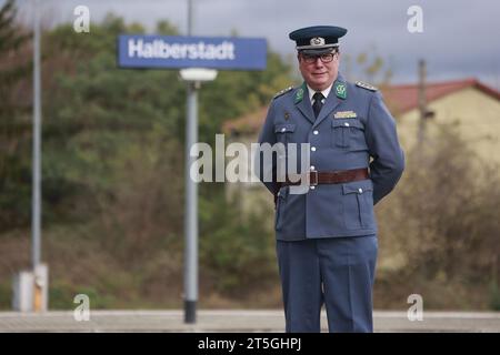 Blankenburg, Germany. 05th Nov, 2023. Railroad fan Christoph Böhm stands in the historic uniform of a GDR customs inspector during a special trip with an old steam locomotive at Halberstadt station. The special trip with steam locomotive 95 027 was organized for the 100th anniversary of the steam locomotive. The Rübelandbahn working group had the historic steam locomotive run from Blankenburg to Halberstadt on two days. Credit: Matthias Bein/dpa/Alamy Live News Stock Photo