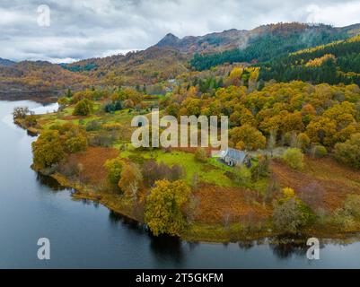 Trossachs, Stirling ,Scotland, UK.  Aerial view of the Trossachs Church beside Loch Achray surrounded by woodland in autumn colours Stock Photo