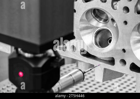 Quality control on milling CNC machine, coordinate measuring machine, Quality control machine. cylinder block of diesel engine repair. Stock Photo