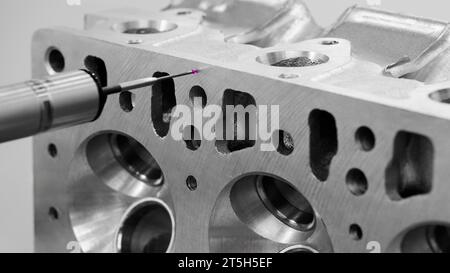 Quality control on milling CNC machine, coordinate measuring machine, Quality control machine. cylinder block of diesel engine repair. Stock Photo