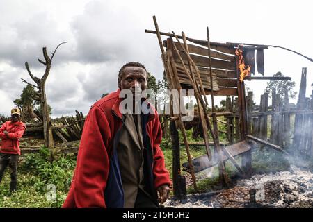 Kenyatta Ngusilo, a member of The Ogiek Community stands in front of his burning storehouse in Sasimwani Mau Forest. Hundreds of people from the Ogiek Community have been left homeless and in biting cold after the Government of Kenya embarked on an eviction exercise to remove alleged encroachers of Mau Forest. A statement by Ogiek People's Development Program (OPDP) said that the eviction of forest communities violates their human rights and called on the government to immediately halt the exercise. (Photo by James Wakibia/SOPA Images/Sipa USA) Stock Photo