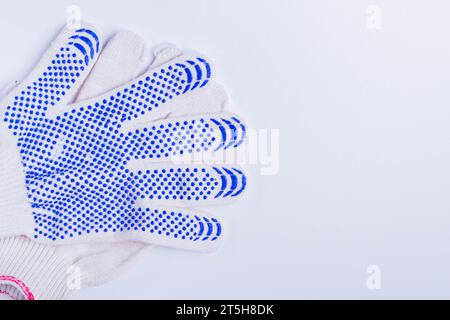Gloves for hand protection at the production site. Shot on a white background, top view.. Stock Photo