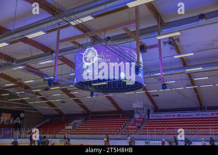 Beautiful view of interior of ice arena at sports complex with both children and adults skating on ice. Stock Photo