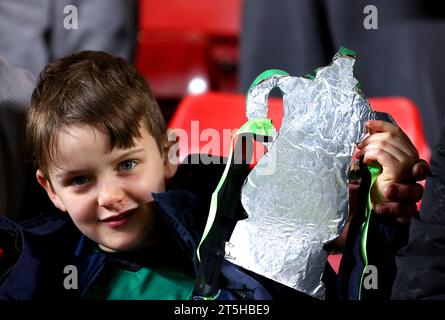 A young fan in the stands holds up a replica of the Emirates FA Cup trophy ahead of the Emirates FA Cup first round match at The Valley, London. Picture date: Sunday November 5, 2023. Stock Photo