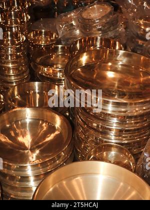 vintage copper plates for the kitchen stacked in rows in the market Stock Photo