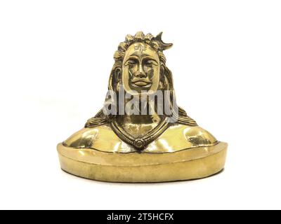 shiny golden idol of lord shiva of hindu religion, antique replica model handcrafted in brass based on adiyogi statue, for car dashboard isolated Stock Photo