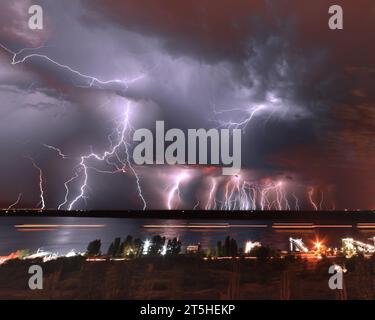 A huge amount of lightning flashing over the water. Volgograd. Russia Stock Photo