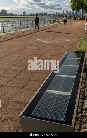 Solar panels on benches by University of East London campus ,offices,and student accommodation in Docklands,London,England,UK Stock Photo