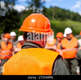 Building concept. Architector, engineers on constructing site. Helmet builder. Many construction workers helmet. Engineer team in hardhat for work Stock Photo