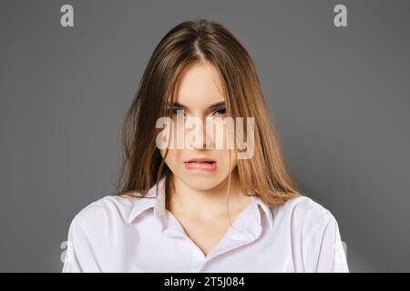 Closeup portrait of a woman who made a mistake and bit her lip Stock Photo