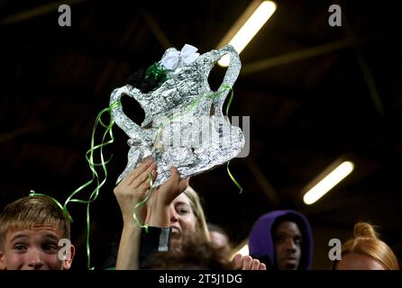 A Cray Valley fan holds up a replica of the Emirates FA Cup trophy at the end of the Emirates FA Cup first round match at The Valley, London. Picture date: Sunday November 5, 2023. Stock Photo