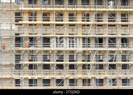London, England, UK - 22 August 2023: Workers on scaffolding on a multi storey building in central London Stock Photo